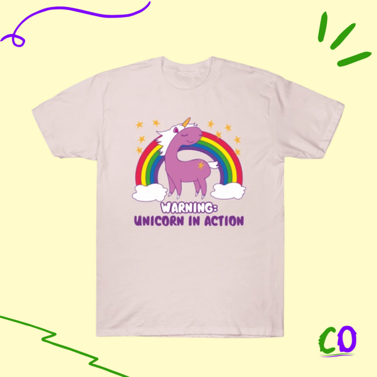 Cute pastel t-shirt with purple unicorn, rainbow, and stars, featuring “Warning: Unicorn in Action” text, fun novelty tee from Creation Overload.